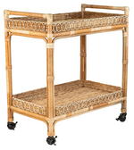 The Juliska Provence Rattan Bar Cart features two shelves, decorative sides, and four black caster wheels—an ideal hosting essential that brings rustic charm to any space.