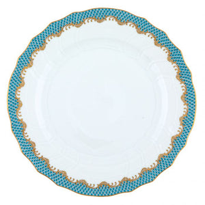 A white hand-painted porcelain plate from the Herend Fish Scale Turquoise Collection, featuring a scalloped edge and a blue and gold patterned border.