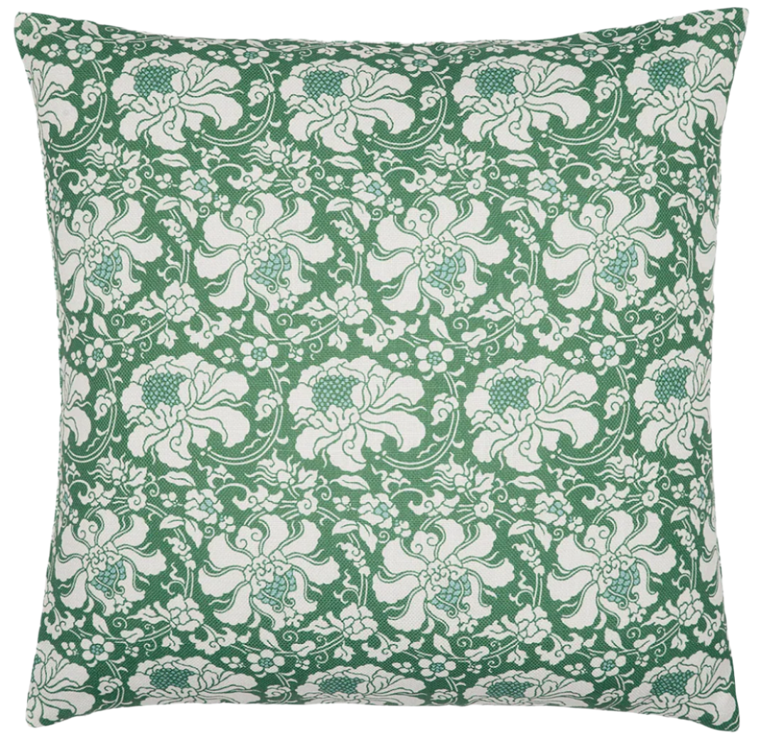 The Haasini Moss Outdoor Pillow by John Robshaw features a green background with a white floral and leaf block print. Sun resistant, it adds lasting beauty to any outdoor space.