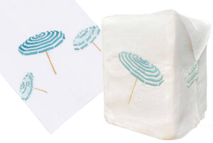 The Haute Home Beach Umbrella Bath Collection in Aqua features an Italian linen napkin and tissue box cover, both hand-embroidered with charming teal and white striped umbrellas.