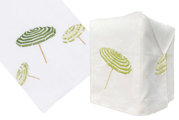 Two views of an Italian linen napkin hand embroidered with designs of the Haute Home Beach Umbrella Collection in Green.
