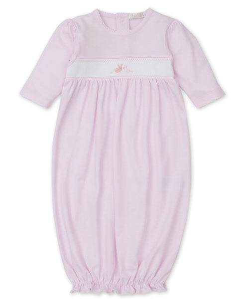 A baby girl's pink Kissy Kissy Premier Bunny Burrows Sack with white ruffles.