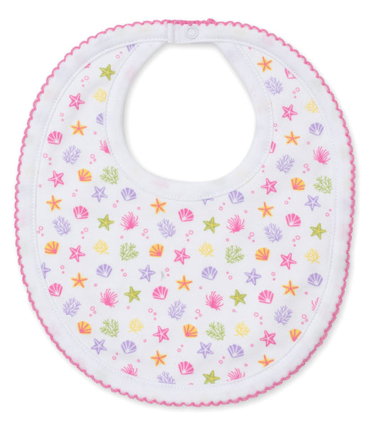 A white Kissy Kissy Under the Sea Printed bib, featuring stars and shells on it, made from soft Pima cotton.
