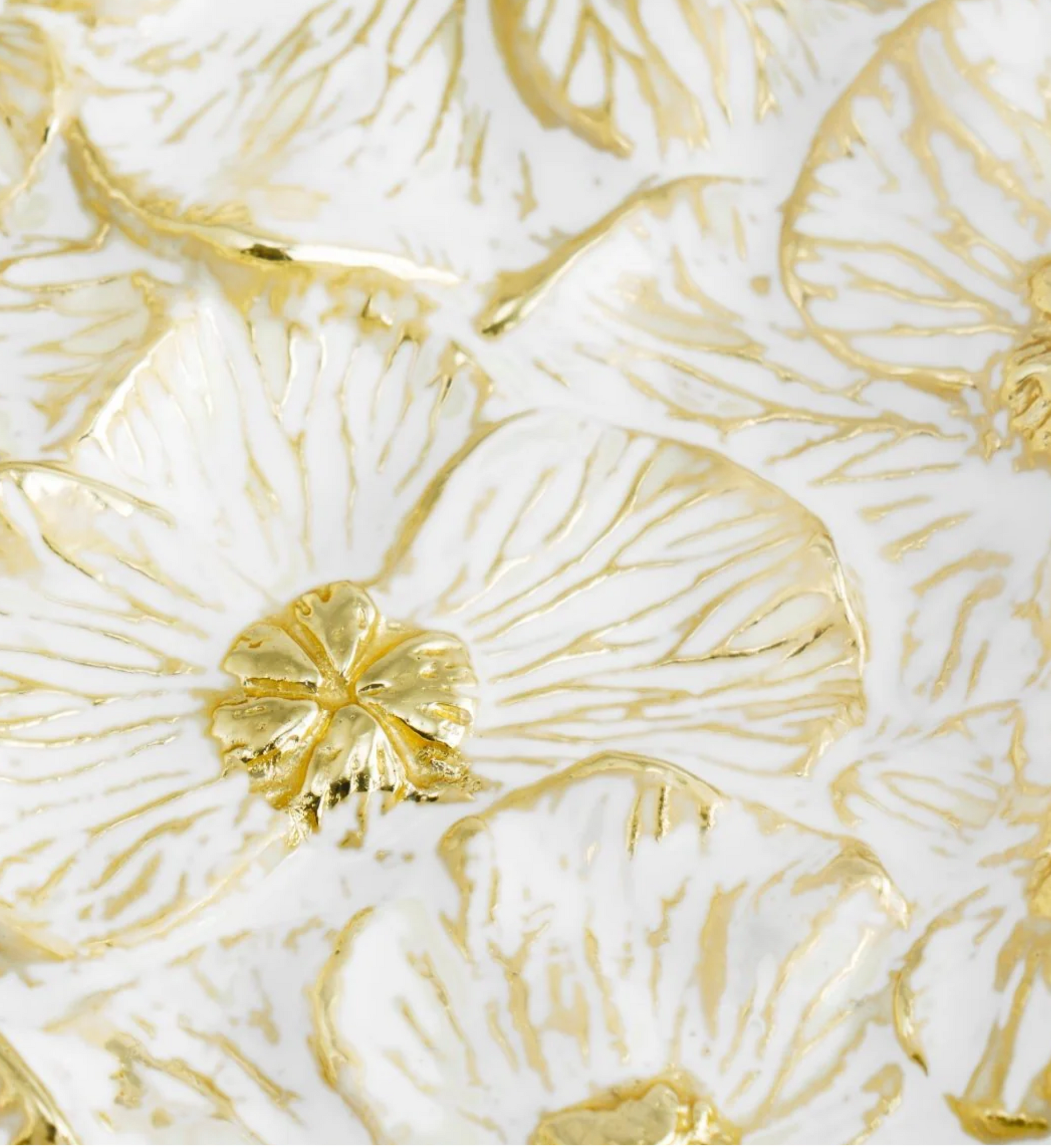 Gold leaf patterns on a white background, featuring intricate Michael Aram Orchid Catch All and floral designs with a metallic sheen.
