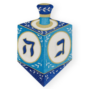 Caspari Dreidel Luncheon Napkins feature blue dreidels with white panels, gold and blue designs, and Hebrew letters, all printed with non-toxic inks for safe holiday celebrations.