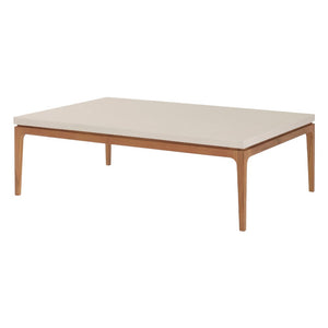 The Sloop Rectangle Cocktail Table by McGuire Furniture features a Bianco Crema Dune top and natural teak frame with four tapered legs—ideal for coastal spaces seeking relaxed charm and natural materials.