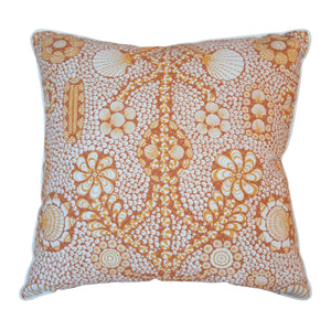 The Burnt Sienna Shell Grotto Outdoor Pillow by Associated Design features an intricate orange and white floral and circular pattern, crafted from premium materials for stylish outdoor décor.