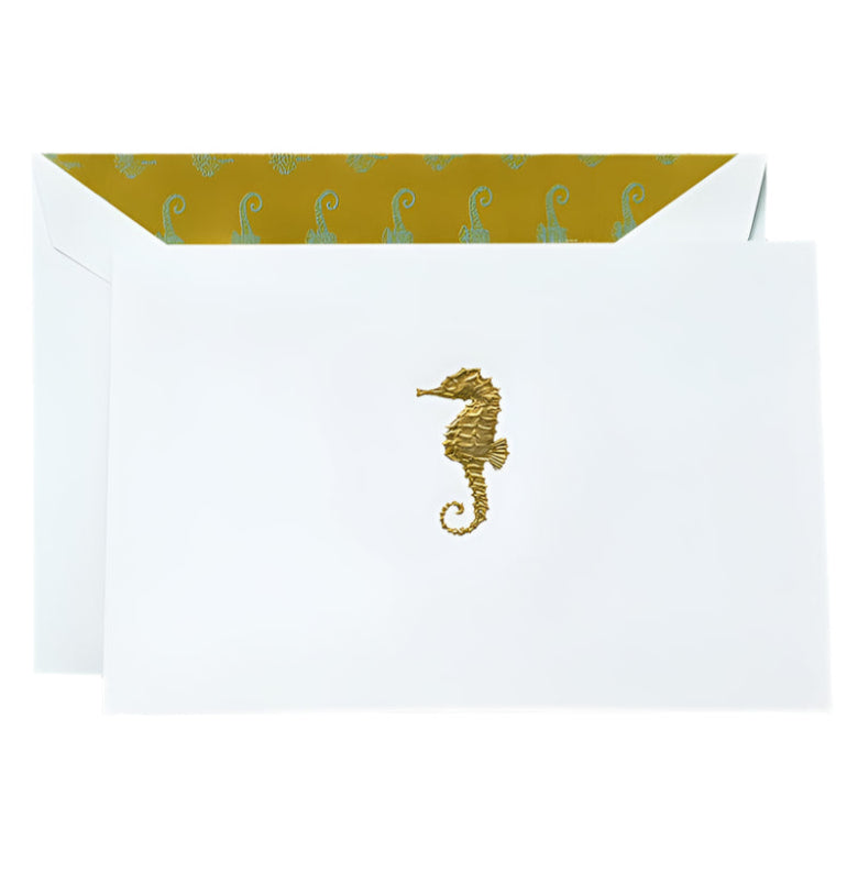 Send your notes in style with Crane’s Gold Seahorse Classic Card Set, featuring white cotton paper envelopes, gold engraved seahorses, and a yellow inner lining with a repeating seahorse pattern.