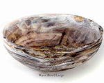The Nashi Home Mocha Resin Serveware Collection features a large round bowl with marbled brown, white, and gray swirls. Food safe and stylish for decor. Text below: "Wave Bowl Large.