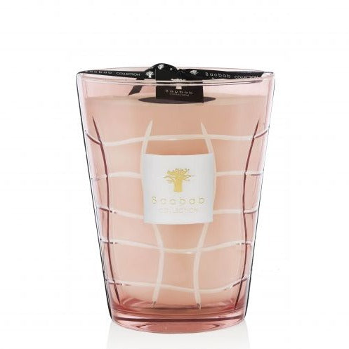 A pink Baobab Waves Malibu candle in a clear glass vessel with a white grid design and logo on the front, transformed into a decorative candle.