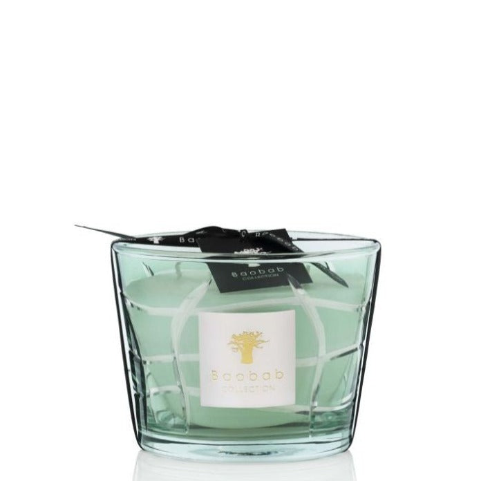 A Baobab Waves Nazare candle with a black ribbon and label on a white background, featuring a subtle scent of lemon tree wood.