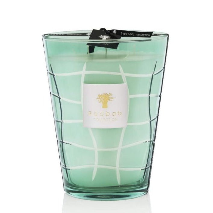 A Baobab Waves Nazare candle in a teal, grid-patterned glass container with a white label featuring a golden lemon tree wood logo.
