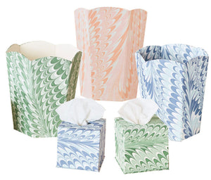 The Marble Bath Collection by Weezie Towels includes five hand-marbled recycled paper containers—two tissue boxes with tissues and three open bins—in green, blue, and peach tones.