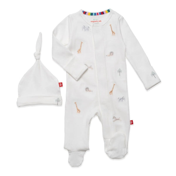 A white baby romper and hat made from GOTS certified organic cotton with adorable giraffes on it.
