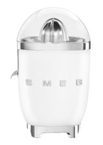 The Smeg Citrus Juicer Collection features a powerful 70W motor, non-drip spout, transparent dome lid, and metallic accents, showcased against a plain background.