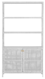 The Isla Bookcase with Hutch White Rattan by Made Goods features a tall, white design with three open shelves and a closed cabinet at the bottom adorned with woven rattan doors.