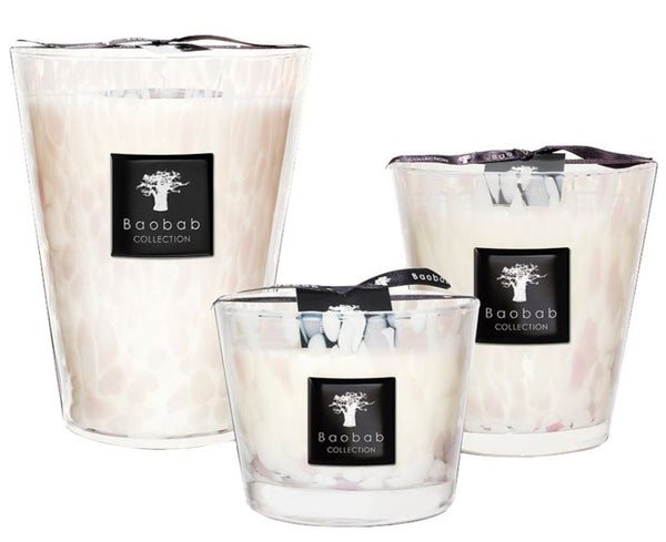 Three Baobab Pearls White Candle Collection scented candles in varying sizes, each in a pearl white glass container with a black label. The White Pearls scented candle features an enchanting blend of jasmine and white.