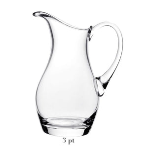 The Whitney Pitcher Collection by William Yeoward Crystal features a clear 3-pint handmade crystal glass pitcher with curved handle and spout—a unique wedding gift, shown empty on a white background.