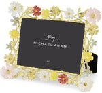 The Michael Aram Wildflowers Frame, 5x7, features hand-enameled gold with pink, yellow, and white floral details inspired by botanical illustrations.