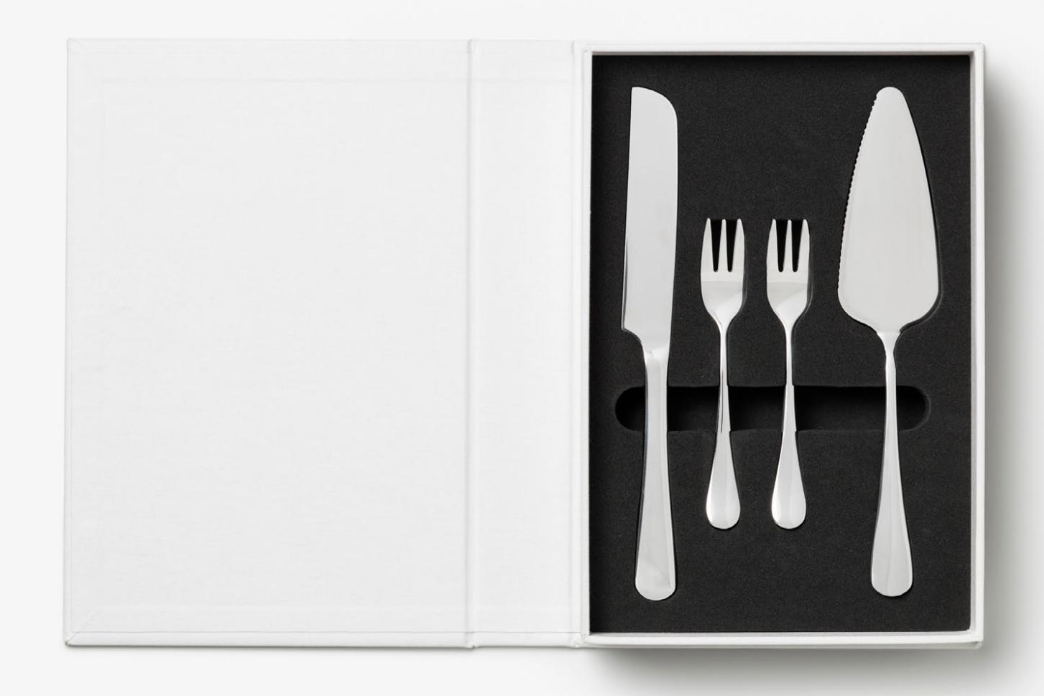 The Essentials Cake Tools by PrintWorks includes a knife, two small forks, and a pie server in foam cutouts, with an empty white panel on the left—an ideal set to elevate your kitchen decor.