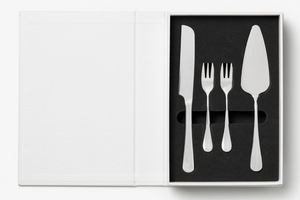 The Essentials Cake Tools by PrintWorks includes a knife, two small forks, and a pie server in foam cutouts, with an empty white panel on the left—an ideal set to elevate your kitchen decor.