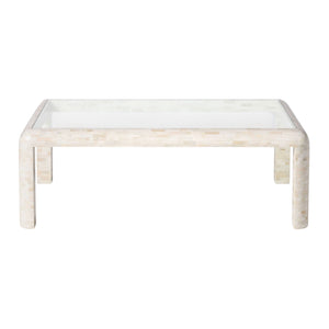 The Made Goods Harley Natural Bone Coffee Table features a rectangular design with a clear glass top, curved horn legs, and a light mosaic-patterned frame.