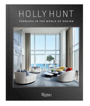 Book cover for Holly Hunt: Fearless In The World of Design by Rizzoli, featuring a sleek modern living room with large windows, contemporary furniture, and an ocean view—highlighting elegant American-inspired interiors.