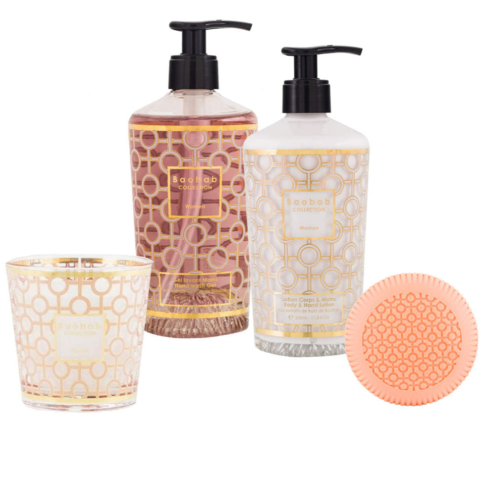 The Baobab Women Body Wellness Collection includes a patterned candle, pink hand soap, white body lotion (both with pumps), and a coral round soap with geometric design—all featuring a delicate floral fragrance.