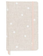 The Essential Flax Dot Journal by Sugar Paper: a beige clothbound notebook with white polka dots, pink elastic closure, and ribbon bookmark—perfect for stylish note-taking.