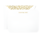 The Crane Gold Thank You Card Set features a white card with "THANK YOU" in gold and an open envelope with a Golden Swirls liner, all expertly crafted by Crane’s artisans.