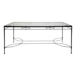 The Amalfi Glass Top Dining Table in Slate by Janus et Cie features a sleek glass top, black metal frame, and minimalist base design—an elegant addition to the Amalfi lounge and dining collection.
