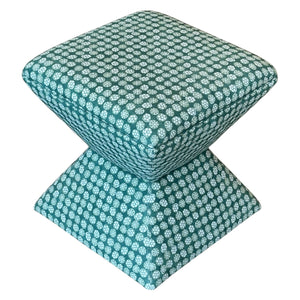 The Hamilton Outdoor Ottoman in Boheme Green by Lee Industries features a square cushioned top with a geometric teal and white floral pattern—ideal for enhancing your patio decor.