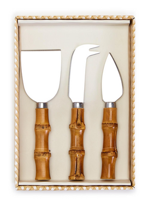 The Two's Company Bamboo Cheese Knife Set features three cheese serving knives with bamboo handles, beautifully arranged in a cream tray.