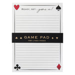 The Karen Adams Game On Notepad has playing card suit corners, lined pages, and "Ready, set...game on!" at the top. An ideal game night essential, it comes with a black band labeled "Game Pad 100 Lined Pages.