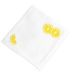 White linen coaster with hand embroidered yellow lemon slices in two corners, from the Lemon Slice Coasters set by Haute Home.