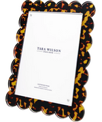 The Tortoise Scallop Frame, 8 x 10 by Tara Wilson Designs features a rectangular Lucite frame with scalloped edges and a tortoiseshell-patterned border.