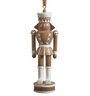 The Zodax Nutcracker Ornament features brown and white paint, a round base, and a hanging ribbon—ideal as festive holiday décor for your Christmas tree.