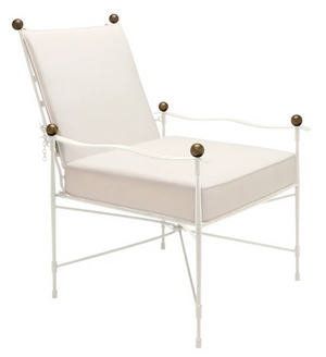 The Amalfi Lounge Chair in White Vermouth with Asti Cushion by Janus et Cie features a white metal frame, white seat and back cushions, and spherical dark bronze finials, blending timeless Etruscan-inspired elegance with modern design.
