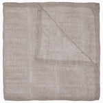 The John Robshaw Nandi Coffee Quilt is a soft cotton voile quilt featuring thin, horizontal brown and white stripes. It's folded to show its reversible design with the same stripe pattern on both sides.