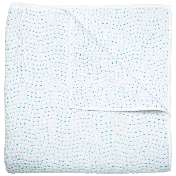 A John Robshaw Hand Stitched Coverlet, Seaglass with hand stitching, featuring a pattern of blue and white dots.