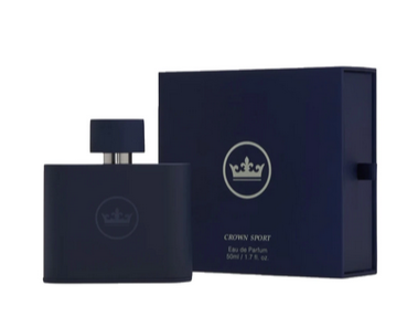 A bottle of Peter Millar Crown Sport Eau de Parfum with an amber cedar scent next to its packaging box.