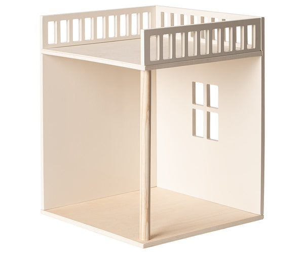 Wooden loft bed structure crafted from linden plywood with an open space below and safety railings on the upper level, serving as a Maileg House of Miniature Bonus Room for the Maileg Family.