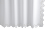 The Matouk Mirasol Shower Curtain in Bone showcases a scalloped edge and a subtle textured pattern, similar to Diamond Pique.