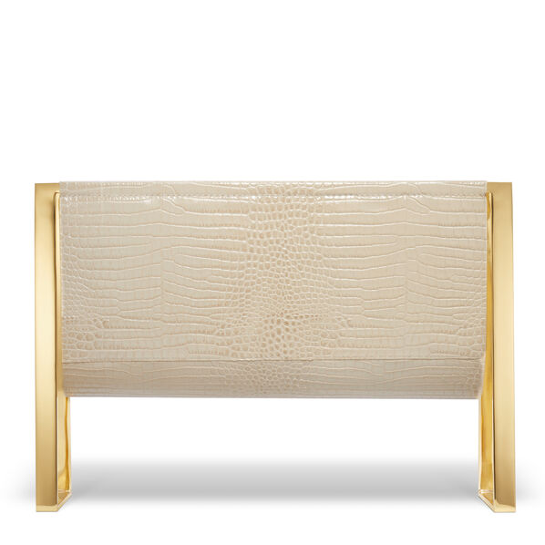 The Classic Croc Magazine Rack in Fawn by Aerin features Italian croc-embossed leather in a cream tone, shaped rectangularly and supported by polished brass frames on each side.