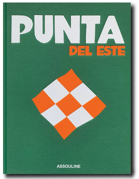 A green and white sign with orange squares in Assouline's Punta del Este.
