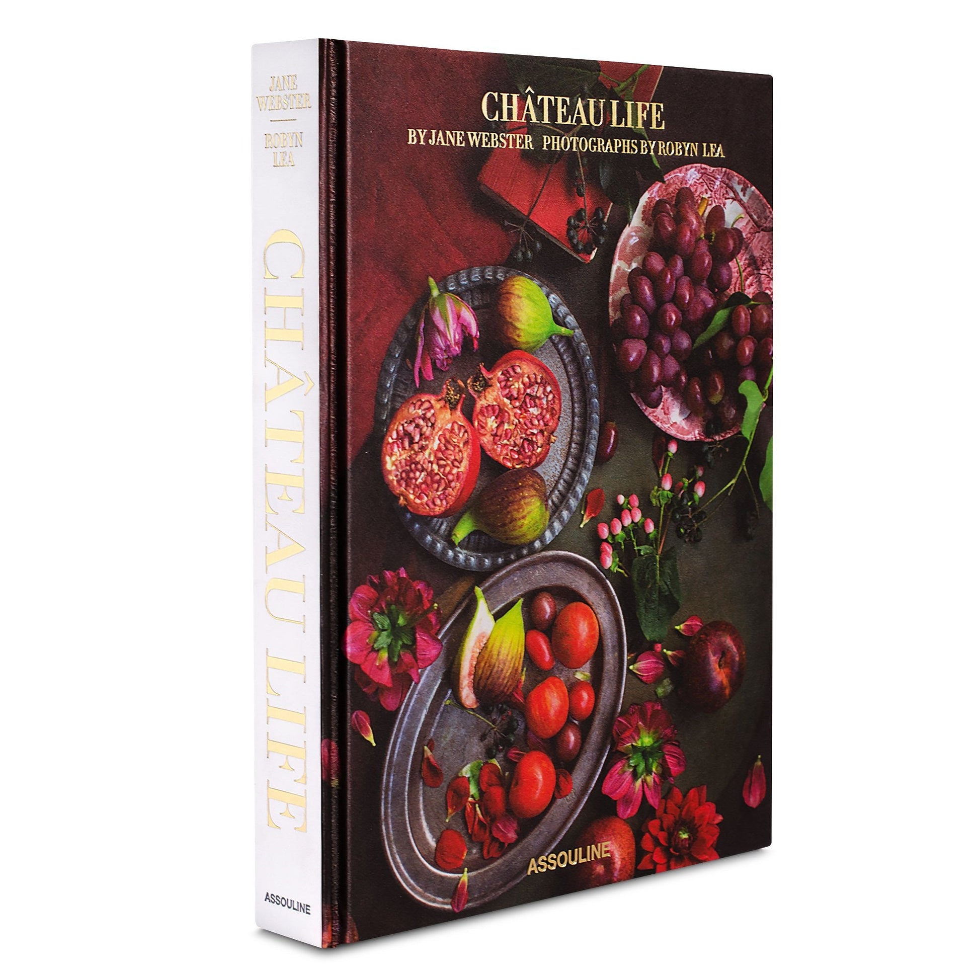 Front cover of the book "Chateau Life" by Assouline, with photographs by Robyn Lea, featuring images of a pomegranate, figs, grapes, and red flowers on a dark background. Discover culinary traditions and French recipes inspired by Château Bosgouet.