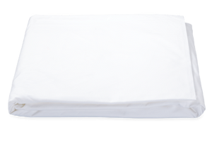 A neatly folded Matouk Ceylon Sheet Collection in white, crafted from high-thread count cotton percale by Matouk, rests on a plain background, promising luxury and durability.