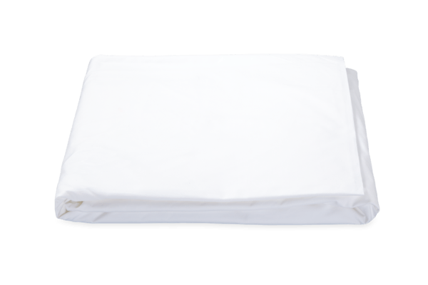 White Matouk Ceylon Fitted Sheet isolated on a green background.