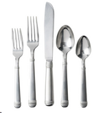 The Juliska Le Panier 5 Piece Flatware Set in Bright Satin features two forks, a knife, a tablespoon, and a teaspoon with decorative handles inspired by equestrian and nautical themes, displayed side by side on a white background.