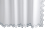 The Matouk Mirasol Shower Curtain in Pool, featuring scalloped edges and light blue trim, elegantly hangs with a blend of style and sustainability. It's crafted to meet OEKO-TEX® Standard 100 certification.